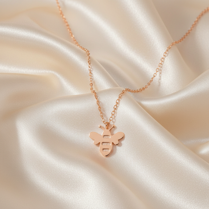 Gold Honey Bee Pendant Necklace on luxe cream satin drape