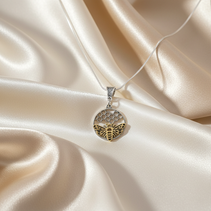 Bee & Honeycomb Pendant Necklace on luxe cream satin drape